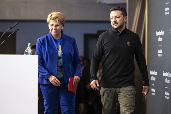 epa11411783 Swiss Federal President Viola Amherd (L) and Ukrainian President Volodymyr Zelensky arrive to attend a media briefing during the Summit on Peace in Ukraine, in Stansstad near Lucerne, Swit ...