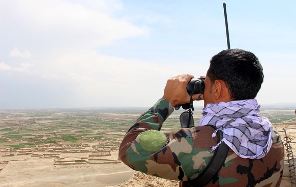 epa09173905 An Afghan soldier stands guard at a military base as soldiers prepare for an operation to recapture the military base that Taliban have overrun, in Arezo village, Ghazni, Afghanistan, 02 M ...