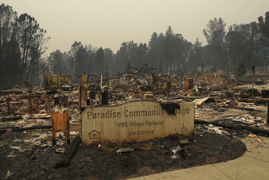 A sign stands at a community destroyed by the Camp fire, Tuesday, Nov. 13, 2018, in Paradise, Calif. (AP Photo/John Locher)