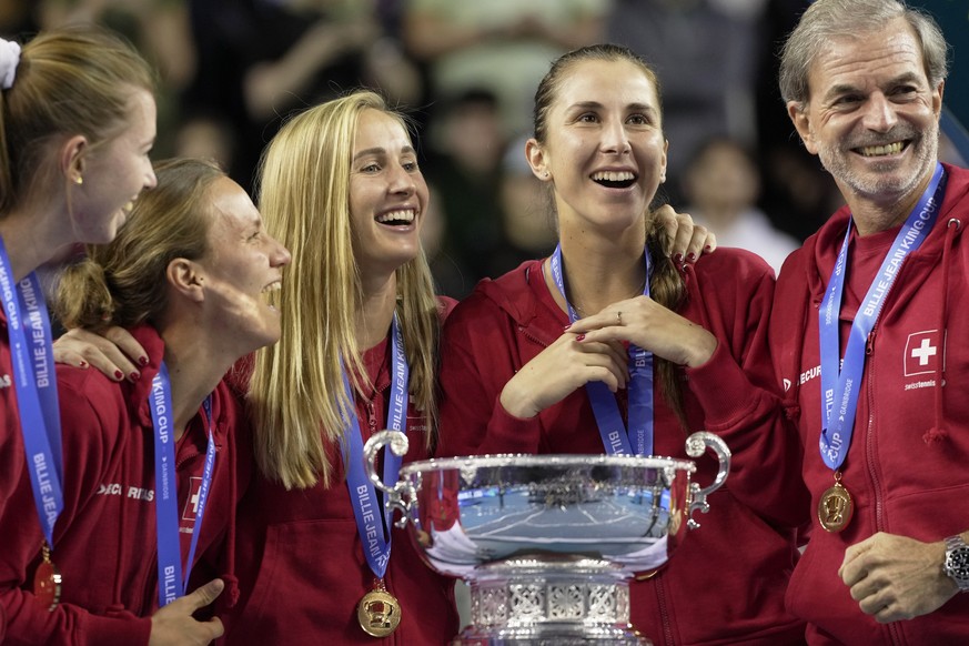 Switzerland&#039;s players Simona Waltert, Viktorija Golubic, Jil Teichmann, Belinda Bencic and Switzerland team captain Heinz Guenthardt, from left, pose with the trophy after defeating Australia to  ...