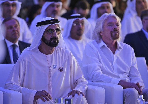 Dubai ruler Sheikh Mohammed bin Rashid Al Maktoum, the Emirates&#039; vice president and prime minister, left, next to Richard Branson watch the Hyperloop One presentation aboard the Queen Elizabeth 2 ...