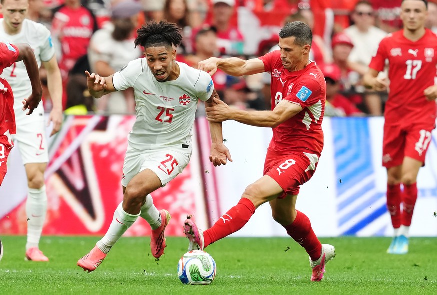 Canada's Nathan-Dylan Saliba (25) dribbles past Switzerland's Remo Freuler (8) during the World Cup Group B soccer match between Switzerland and Canada in Vancouver, British Columbia, Wednes ...