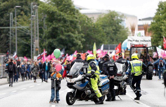 epa06061476 Police monitor a protest against the G20 summit in Hamburg, northern Germany, 02 July 2017. The G20 Summit (or G-20 or Group of Twenty) is an international forum for governments from 20 ma ...