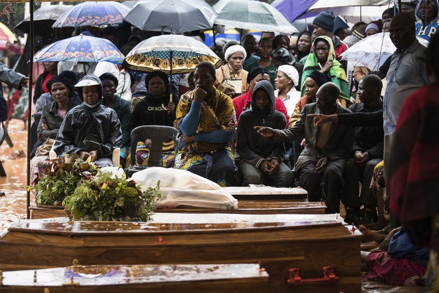 People attend the burial ceremony of some of the people who lost their lives following heavy rains caused by Cyclone Freddy in Blantyre, southern Malawi, Wednesday, March 15, 2023. After barreling thr ...