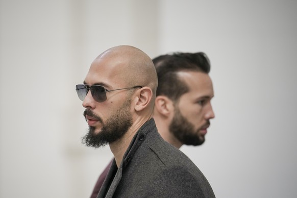 FILE - Andrew Tate, left, and his brother Tristan, right, wait inside the Court of Appeals building in Bucharest, Romania, Tuesday, Jan. 30, 2024. A court in Romania&#039;s capital on Friday, July 5,  ...