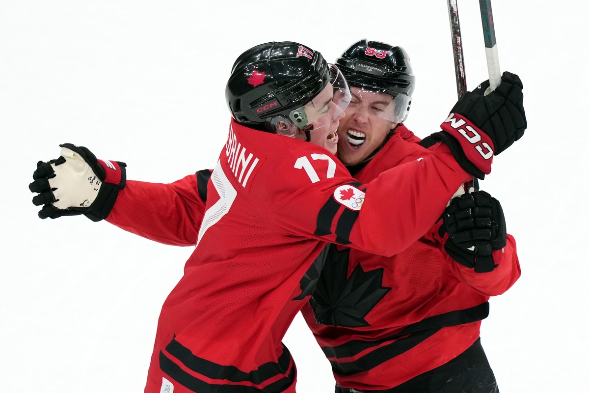 Canada's Mitch Marner (93) and Macklin Celebrini (17) celebrate after Marner scored the winning goal during the overtime period of a men's ice hockey quarterfinal game between Canada and Cze ...