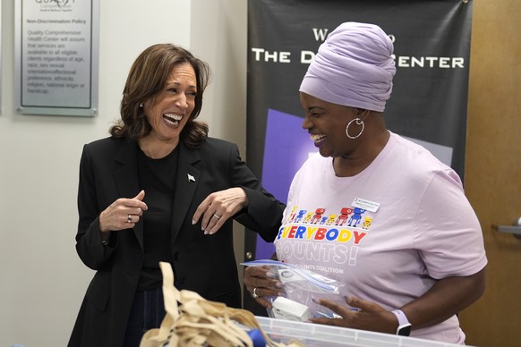 Democratic presidential nominee Vice President Kamala Harris, left, greets a worker at a food drop-off and distribution center after receiving a briefing on the damage from Hurricane Helene, Saturday, ...