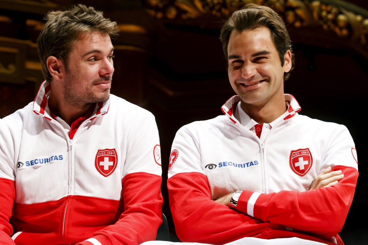 Stan Wawrinka, left, of Switzerland, and Roger Federer, right, of Switzerland, smiles at the Victoria Hall, during the drawing for the Davis Cup World Group Semifinal match between Switzerland and Ita ...