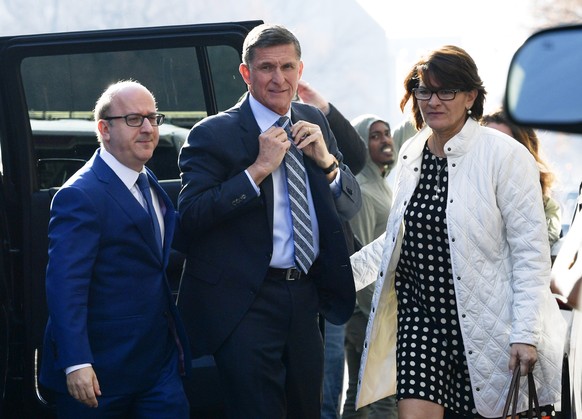 Former Trump national security adviser Michael Flynn, center, arrives at federal court in Washington, Friday, Dec. 1, 2017. Court documents show Flynn, an early and vocal supporter on the campaign tra ...