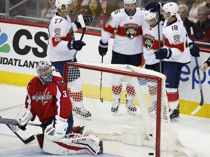 Florida Panthers center Denis Malgin (62) celebrates with teammates Nick Bjugstad (27), left wing Thomas Vanek (26) and right wing Reilly Smith (18) during the third period of an NHL hockey game in Wa ...