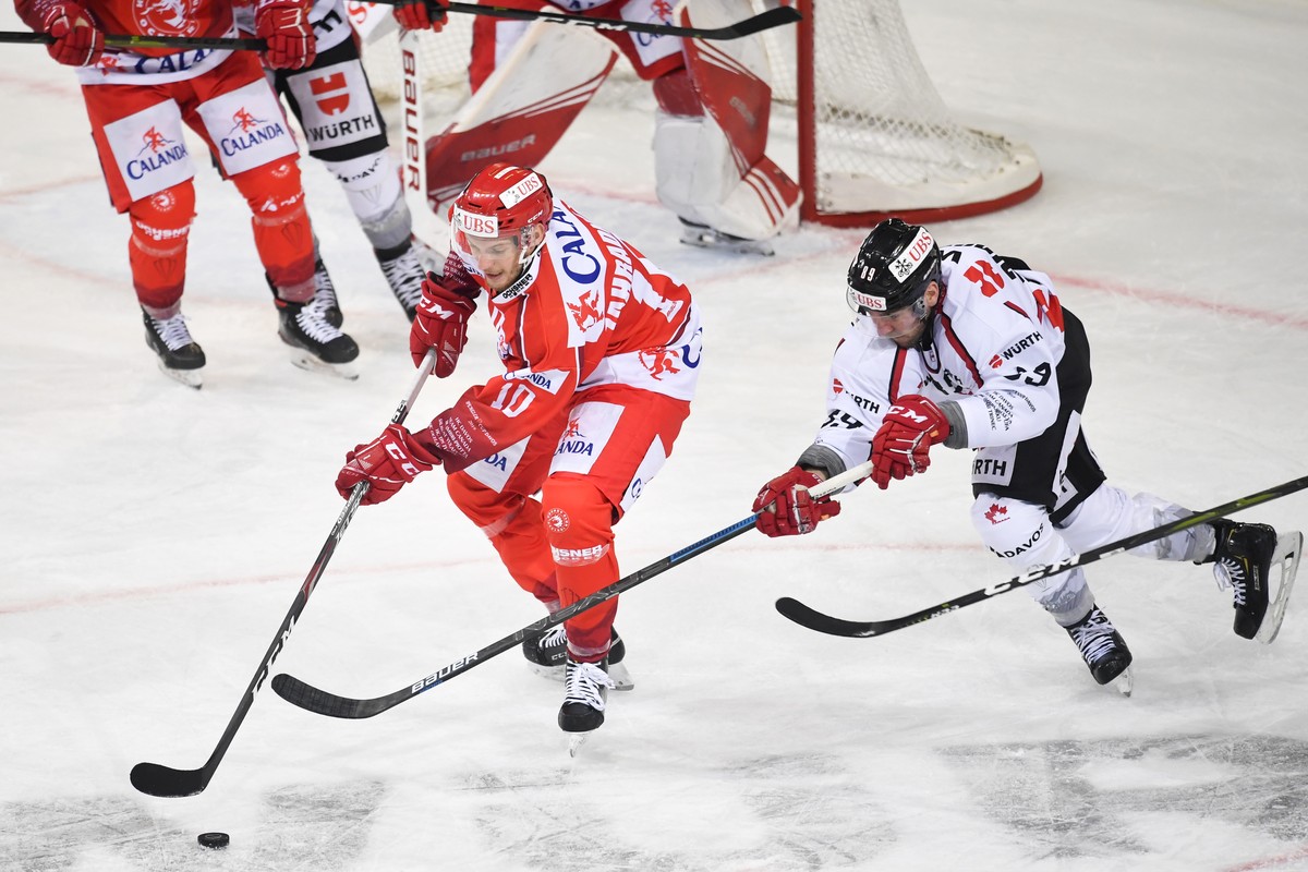 epa08091317 Trinec's Jan Zahradnicek (L) versus Canada's Chris Didomenico, during the game between HC Ocelari Trinec and Team Canada, at the 93th Spengler Cup ice hockey tournament in Davos, ...