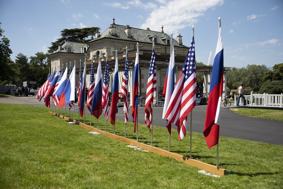 epa09273036 Flags of the US and Russia photographed in the garden in front of the villa La Grange, one day prior to the US - Russia summit in Geneva, Switzerland, 15 June 2021. The meeting between US  ...