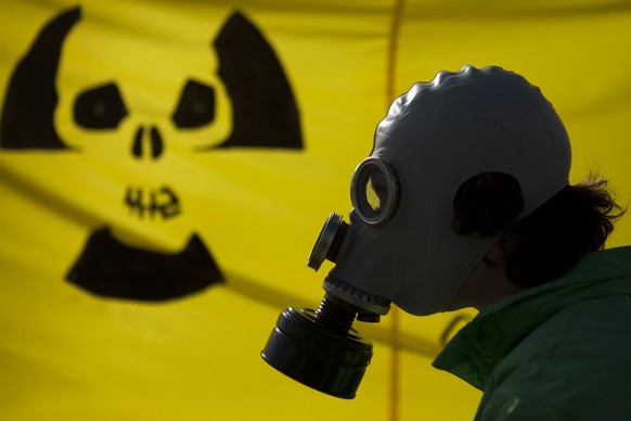 FILE - A man with a gas mask protests near the chancellery against nuclear power in the wake of Japan&#039;s Fukushima reactor disaster in Berlin, March 26, 2011. The country&#039;s three remaining re ...