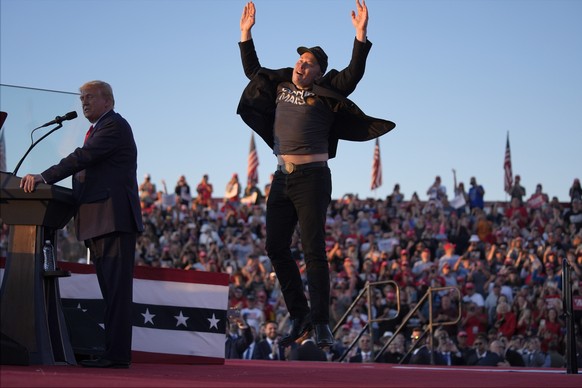 FILE - Elon Musk jumps on the stage as Republican presidential nominee former President Donald Trump speaks at a campaign rally at the Butler Farm Show, Oct. 5, 2024, in Butler, Pa. (AP Photo/Evan Vuc ...