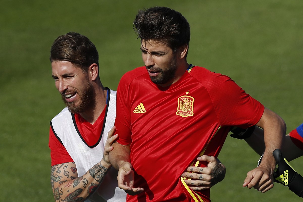 FILE - In this June 24, 2016 file photo, Spain's Sergio Ramos, left, grabs Gerard Pique during a training session at the Sports Complex Marcel Gaillard in Saint Martin de Re in France. Sergio Ram ...