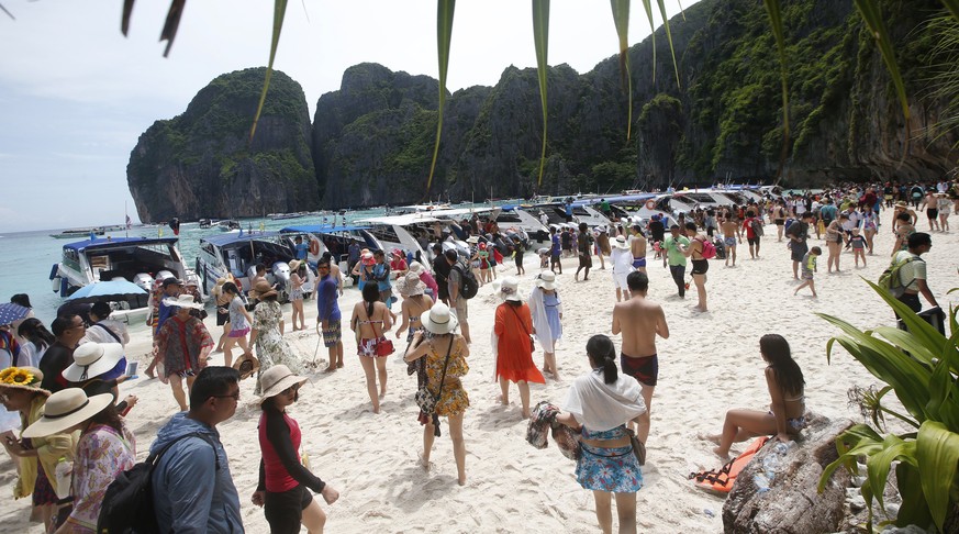 Tourists enjoy the beach on Maya Bay, Phi Phi Leh island in Krabi province, Thailand, Thursday, May 31, 2018. The popular tourist destination of Maya Bay in the Andaman Sea will close to tourists for  ...