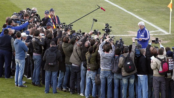 FILE - In this Sunday, June 20, 2010, file photo, France&#039;s soccer coach Raymond Domenech is surrounded by the media, while reading a letter from his players who decided to cancel the training ses ...