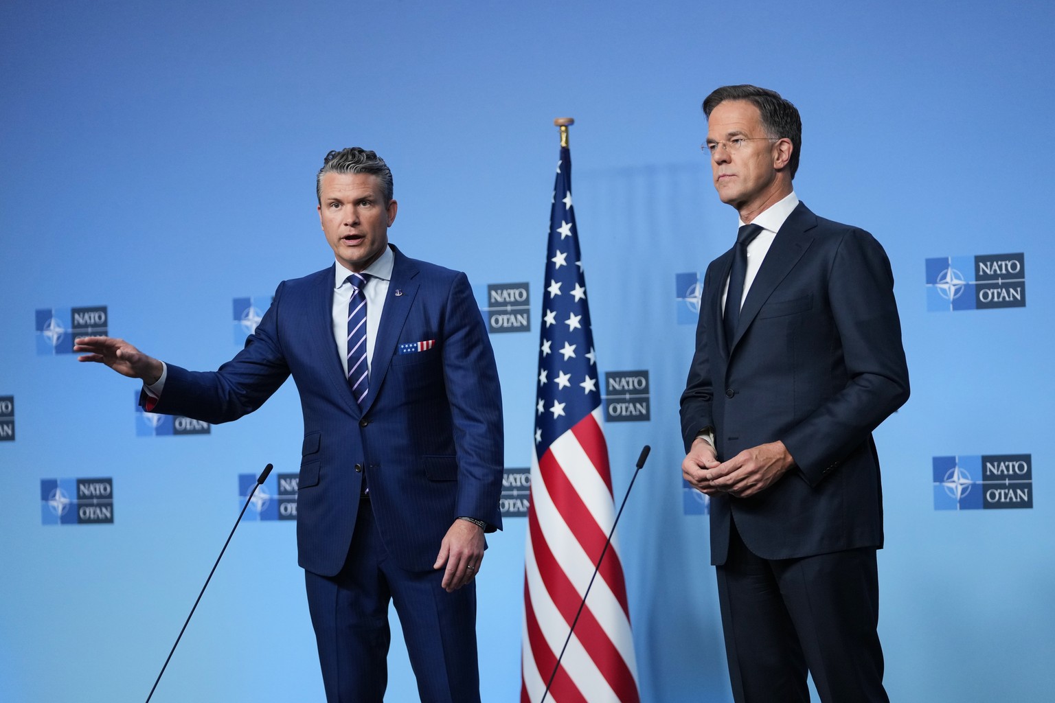 NATO Secretary General Mark Rutte, right, and United States Defense Secretary Pete Hegseth address the media prior to a meeting of NATO defense ministers at NATO headquarters in Brussels, Wednesday, O ...