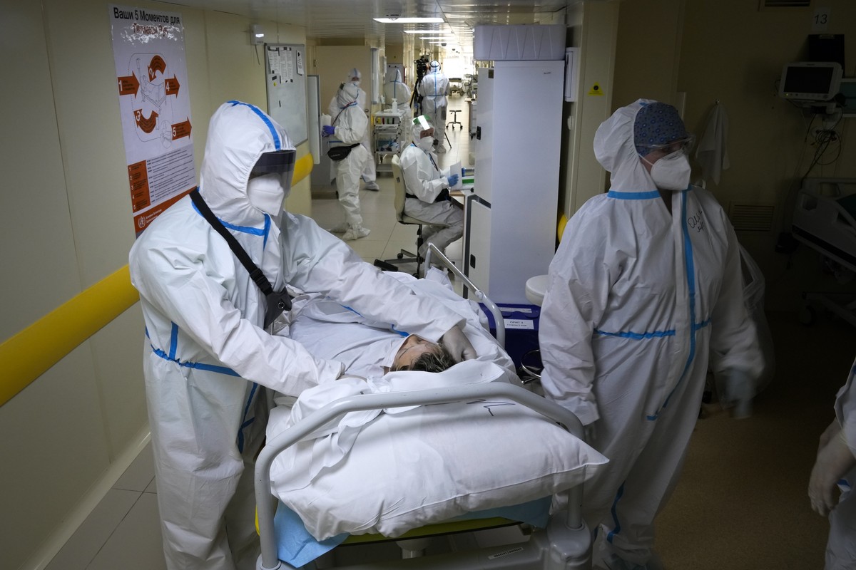 Medics wearing special suits to protect against coronavirus move a patient with coronavirus at an ICU at the Moscow City Clinical Hospital 52, in Moscow, Russia, Tuesday, Oct. 19, 2021. Russia hit ano ...