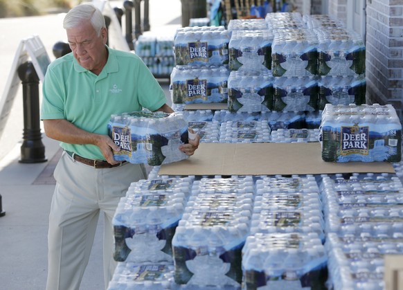 Larry Pierson, from the Isle of Palms, S.C., purchases bottled water from the Harris Teeter grocery store on the Isle of Palms in preparation for Hurricane Florence at the Isle of Palms S.C., Monday,  ...