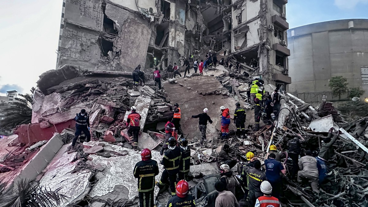 epa12875776 First responders search for missing people under the rubble of a partially destroyed residential building following an Israeli air strike, in the Tallet al-Khayat neighborhood of Beirut, L ...