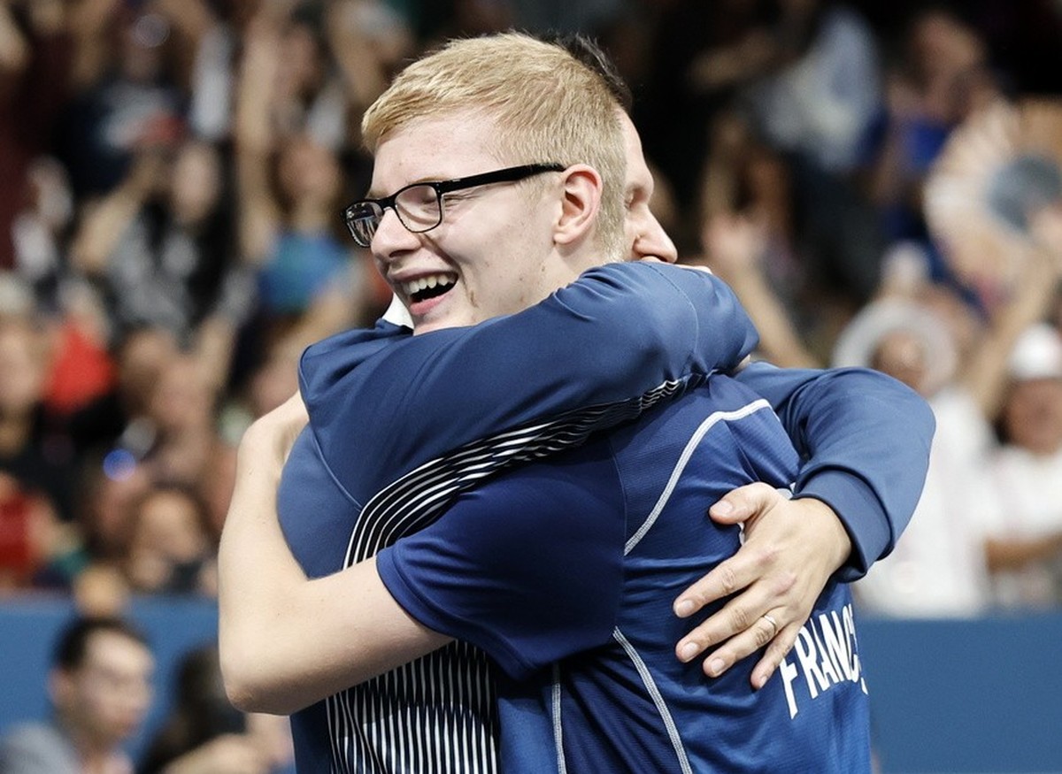 epa11524521 Felix Lebrun of France hugs his coach after winning the Men's Singles Bronze Medal Match against Hugo Calderano of Brazil at the Table Tennis competitions in the Paris 2024 Olympic Ga ...