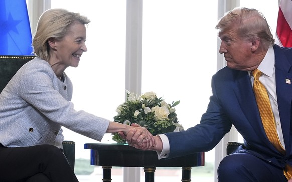 President Donald Trump and European Commission President Ursula von der Leyen shake hands after reaching a trade deal at the Trump Turnberry golf course in Turnberry, Scotland Sunday, July 27, 2025. ( ...