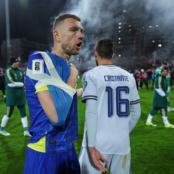 Bosnia's Edin Dzeko, left, greets Italy's Bryan Cristante after a penalty shootout during the World Cup qualifying playoff final soccer match between Bosnia and Italy in Zenica, Bosnia, Tues ...