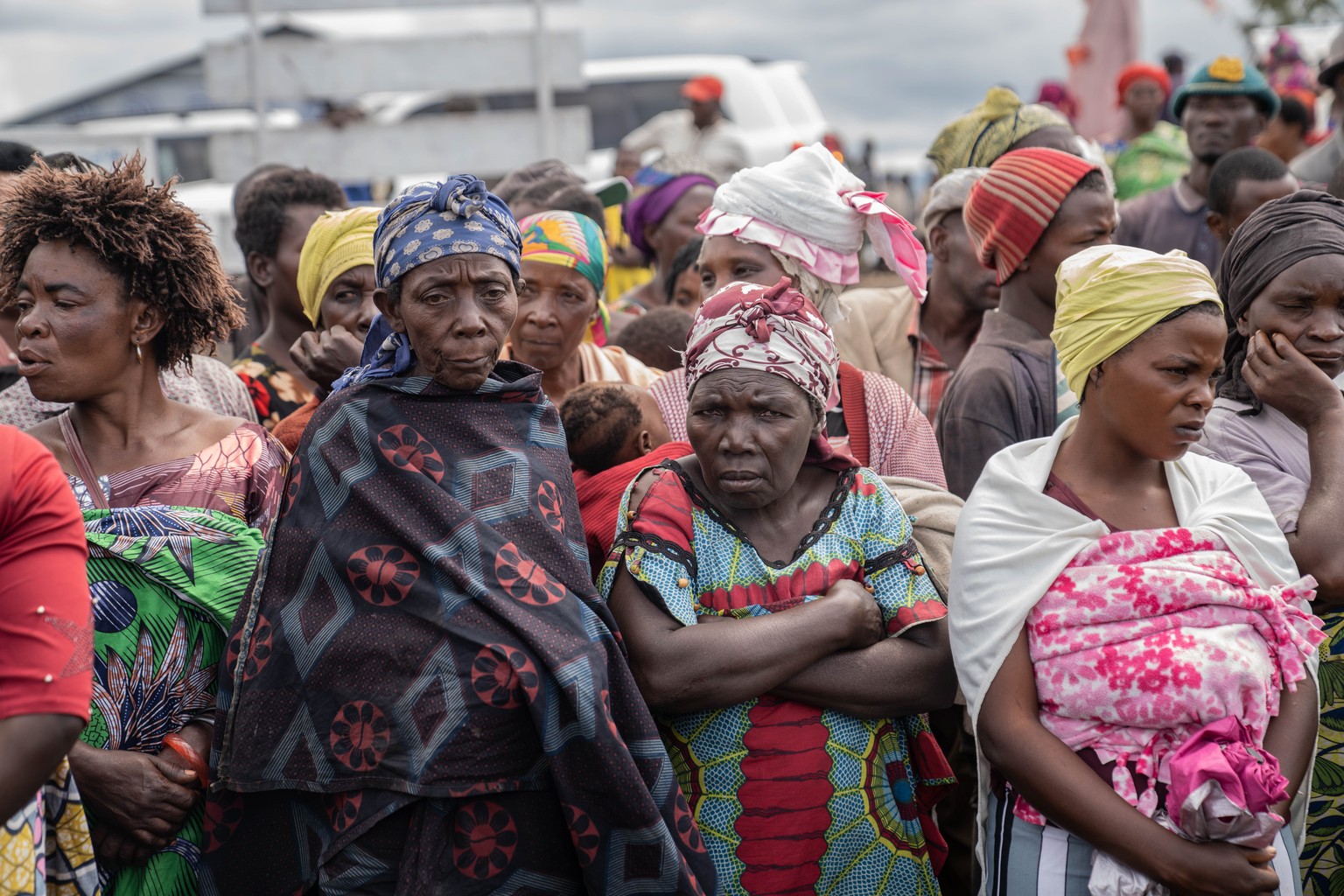 epa11284123 Refugees look on during a visit by UN High Commissioner for Human Rights Volker Tuerk (not pictured) to the Bulengo camp for internally displaced people, near Goma, Democratic Republic of  ...