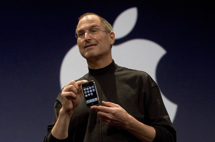 SAN FRANCISCO, CA - JANUARY 9: Apple CEO Steve Jobs holds up the new iPhone that was introduced at Macworld on January 9, 2007 in San Francisco, California. The new iPhone will combine a mobile phone, ...