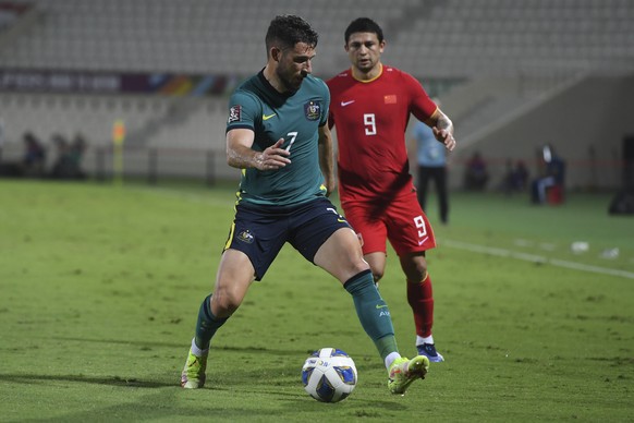 Australia&#039;s Mathew Leckie, front, and China&#039;s Kesen Ai fight for the ball during a a qualifying soccer match for the FIFA World Cup Qatar 2022 between China and Australia in Sharjah, the Uni ...