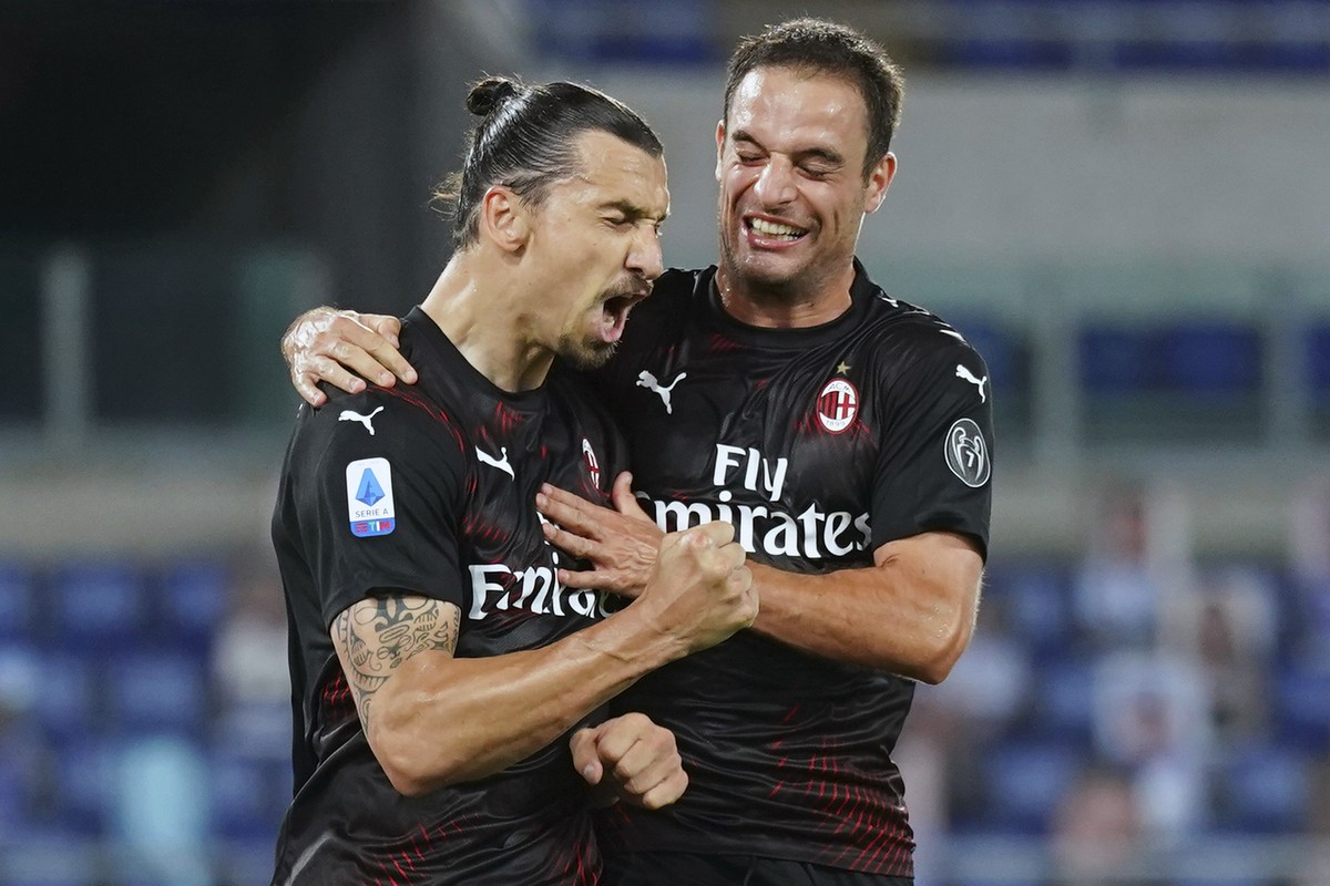 AC Milan's Zlatan Ibrahimovic, left, celebrates with Giacomo Bonaventura after scoring his side's 2nd goal on a penalty, during the Serie A soccer match between Lazio and AC Milan at the Rom ...