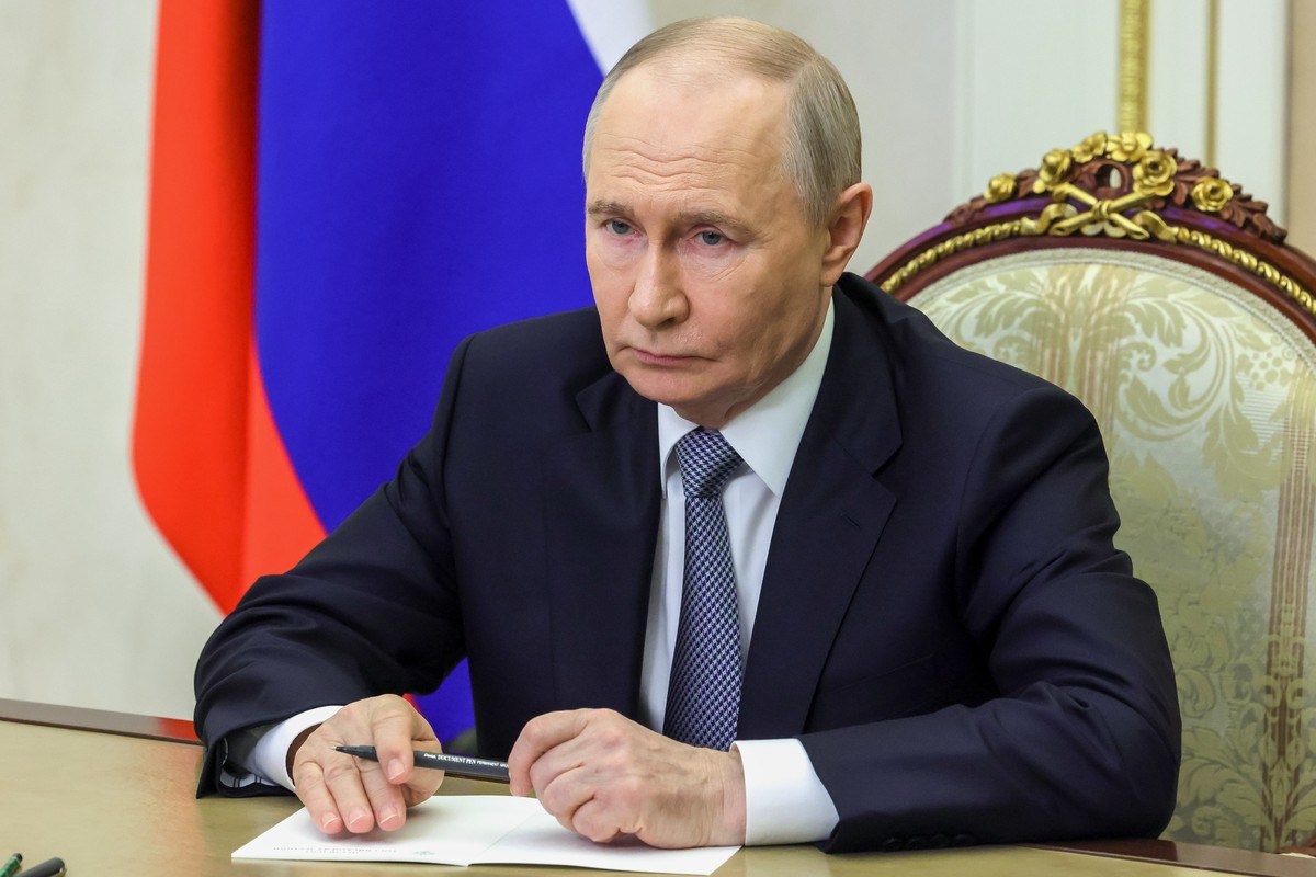 Russian President Vladimir Putin listens as Russian Strategic Missile Forces chief, Col. Gen. Sergei Karakayev reports to him on a successful test launch of the Sarmat intercontinental ballistic missi ...