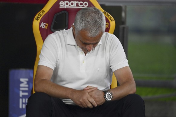 Roma coach Jose Mourinho looks down as he sits on the bench during the Serie A soccer match between Roma and Fiorentina, at the Rome Olympic stadium, Sunday, Aug. 22, 2021. (Alfredo Falcone /LaPresse  ...