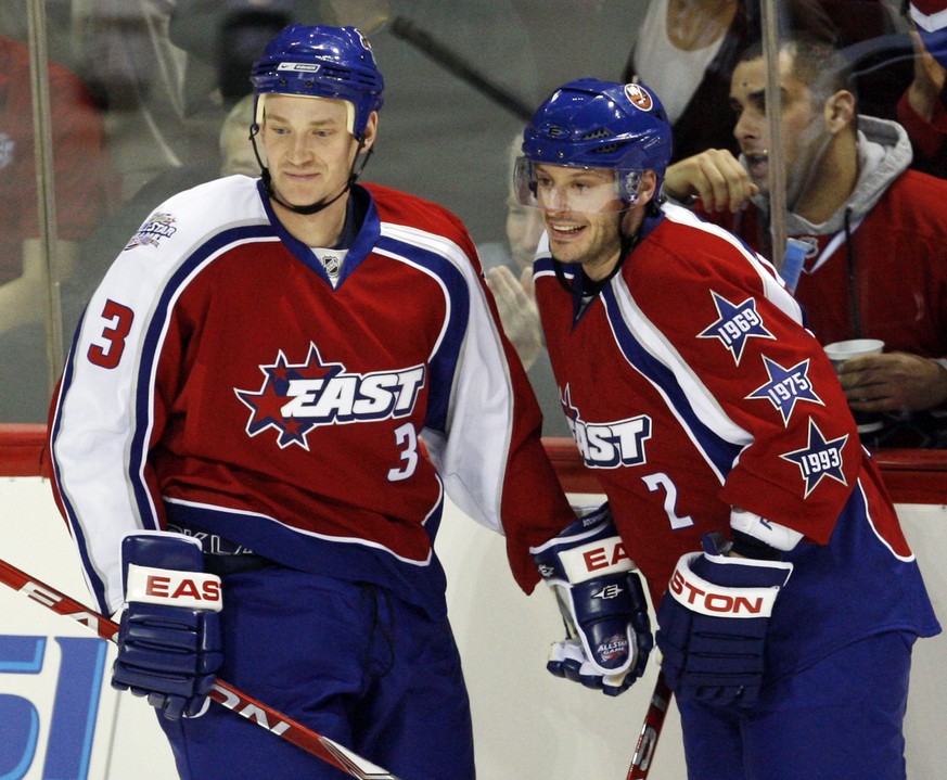 New York Islanders Mark Streit (2) and Florida Panthers Jay Bouwmeester celebrate a goal by the Eastern Conference during the National Hockey League All-star game in Montreal Sunday, Jan. 25, 2009. (A ...