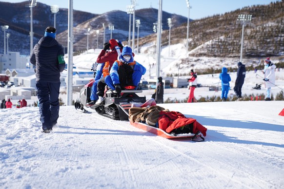 epa09761190 Irene Cadurish of Switzerland is carried on a rescue sled during the Women&#039;s Biathlon 4x6km Relay race at the Zhangjiakou National Biathlon Centre at the Beijing 2022 Olympic Games, Z ...