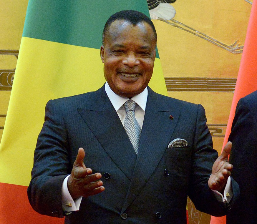 Congo President Denis Sassou-Nguesso, left, reacts as he attends a signing ceremony with Chinese President Xi Jinping at the Great Hall of the People in Beijing on Thursday, June 12, 2014. (AP Photo/W ...