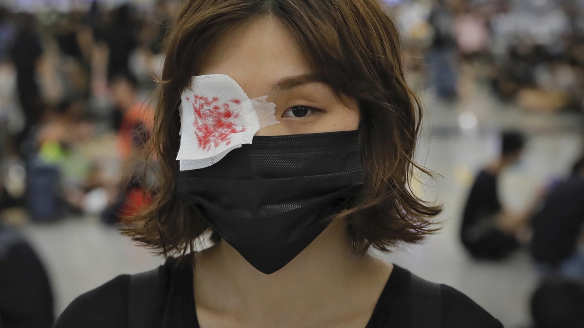 A protester wears an eyepatch during a sit-in protest at the Hong Kong International Airport in Hong Kong, Monday, Aug. 12, 2019. One of the world's busiest airports canceled all flights after th ...