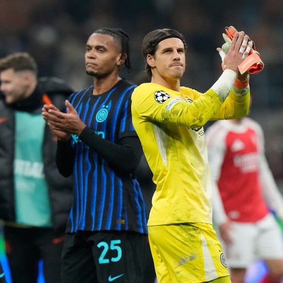 Inter Milan's goalkeeper Yann Sommer, right and Inter Milan's Manuel Akanji react at the end of the Champions League opening phase soccer match between Inter Milan and Arsenal in Milan, Ital ...