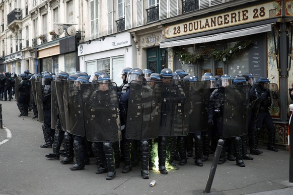 epa10415950 French police forces secure a position as clashes erupted with protesters during a national strike against the government&#039;s reform of the pension system, in Paris, France, 19 January  ...