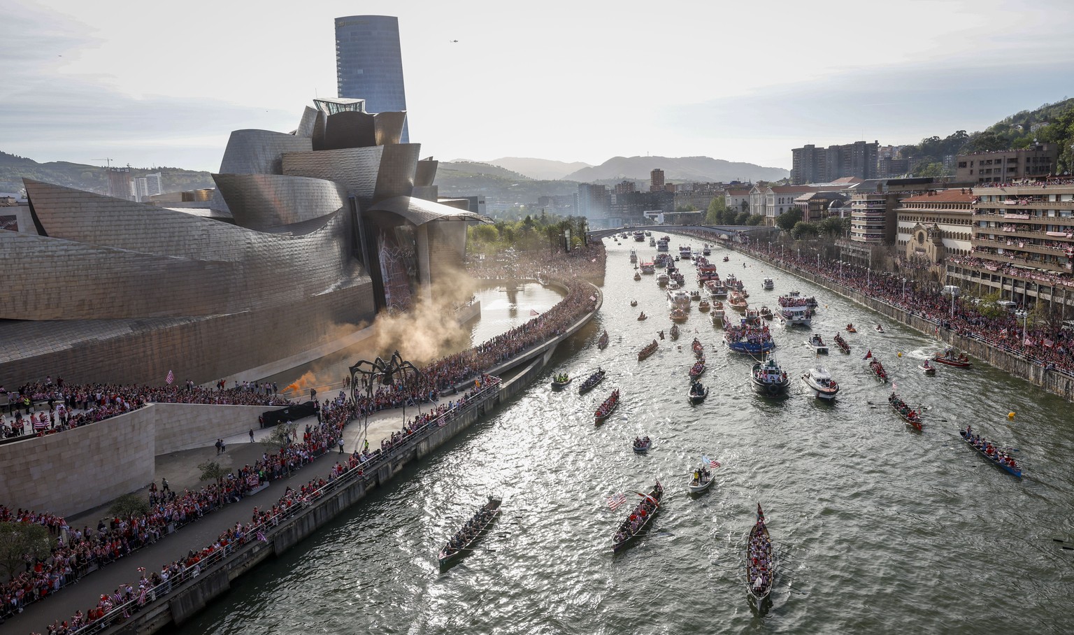 epa11273124 Dozens of boats pass by the Guggenheim Museum as they sail along Nervion estuary during the Spanish King&#039;s Cup trophy parade aboard the popular &#039;Gabarra&#039; (barge), in Bilbao, ...