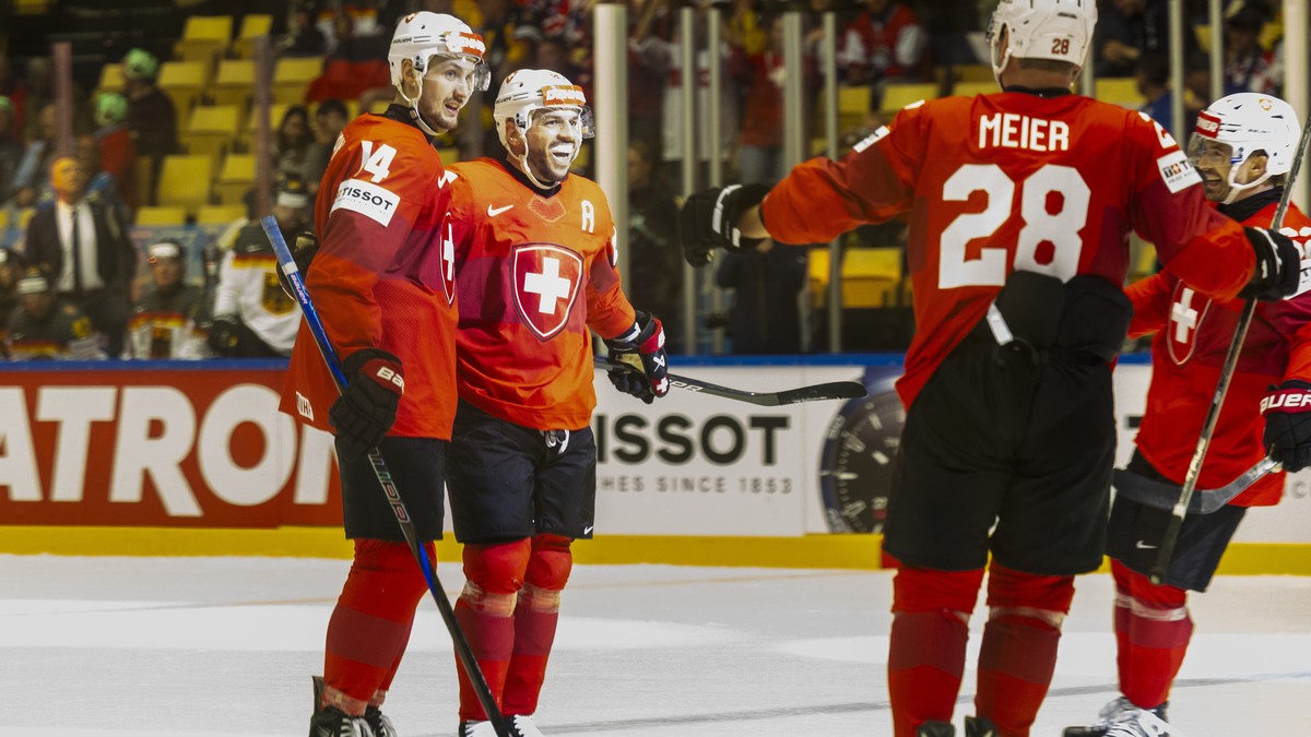 epa12103111 Switzerland's forward Sven Andrighetto, 2nd left, celebrates his goal with his teammates Switzerland's defender Dean Kukan #14, Switzerland's forward Timo Meier #28 and Swit ...