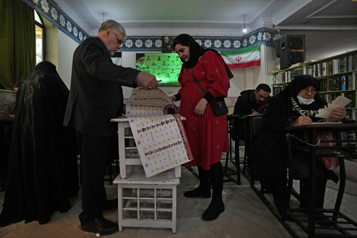 Voters fill out their ballots during the parliamentary and Assembly of Experts elections at a polling station in Tehran, Iran, Friday, March 1, 2024. Iran on Friday held the country's first elect ...