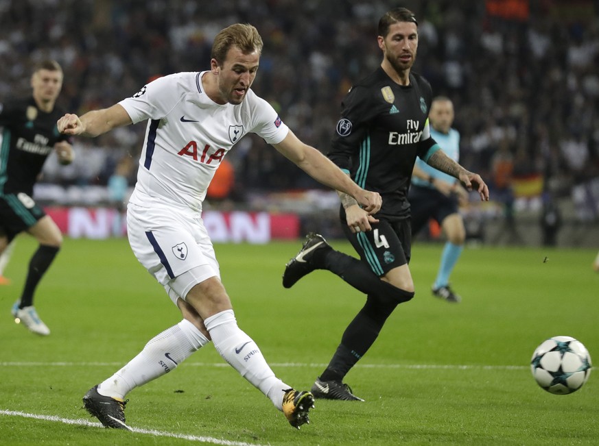 Tottenham&#039;s Harry Kane passes the ball as Real Madrid&#039;s Sergio Ramos runs alongside during a Champions League Group H soccer match between Tottenham Hotspurs and Real Madrid at the Wembley s ...