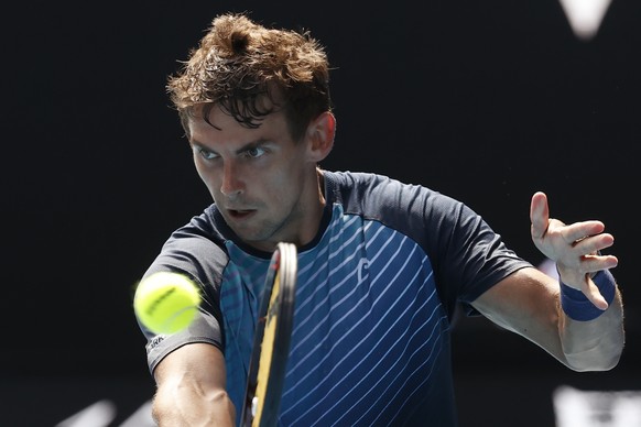 Henri Laaksonen of Switzerland plays a backhand return to Daniil Medvedev of Russia during their first round match at the Australian Open tennis championships in Melbourne, Australia, Tuesday, Jan. 18 ...