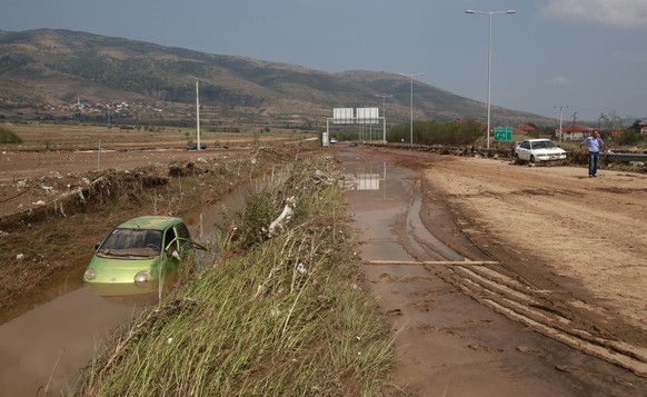A flooded vehicle is pictured in a ditch by a motorway, after an overnight storm near the village of Stajkovci, just east of Skopje, Macedonia, Sunday, Aug. 7, 2016. The Macedonian capital of Skopje h ...