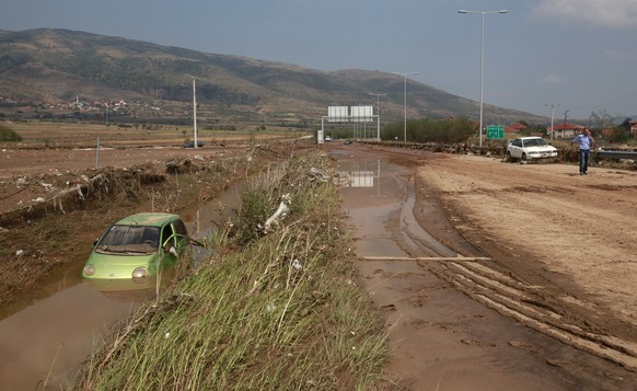 A flooded vehicle is pictured in a ditch by a motorway, after an overnight storm near the village of Stajkovci, just east of Skopje, Macedonia, Sunday, Aug. 7, 2016. The Macedonian capital of Skopje h ...