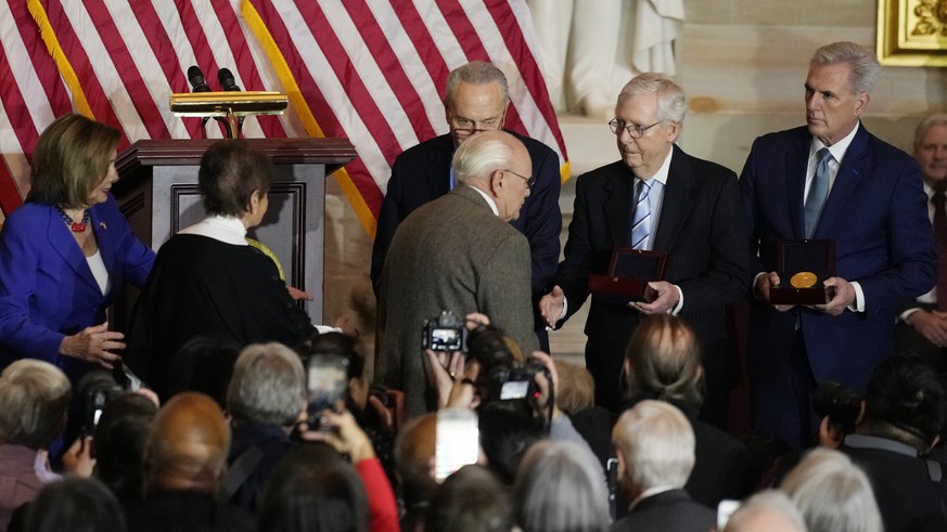 Charles and Gladys Sicknick, father and mother of slain U.S. Capitol Police Officer Brian Sicknick, are greeted by Senate Majority Leader Chuck Schumer of N.Y., center, with Senate Minority Leader Mit ...