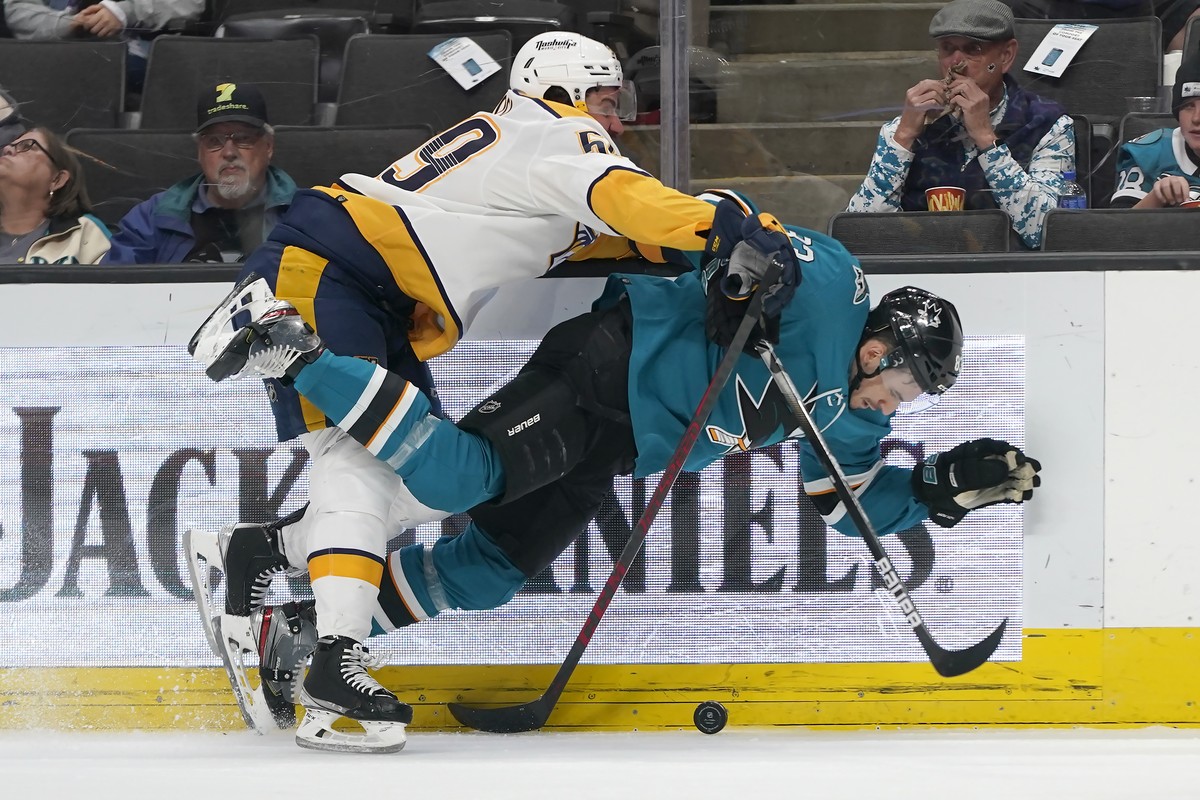 San Jose Sharks left wing Matt Nieto, bottom, is knocked to the ice by Nashville Predators defenseman Roman Josi during the first period of an NHL hockey game in San Jose, Calif., Saturday, March 5, 2 ...