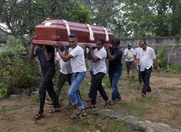 Relatives carry the coffin of Calistas Fernando for burial during the funerals of three people of the same family, all died at Easter Sunday bomb blast at St. Sebastian Church in Negombo, Sri Lanka, M ...